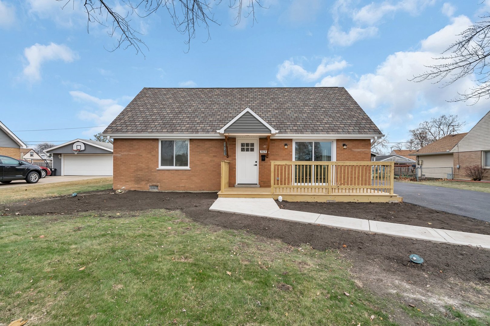 a front view of a house with a garden and yard