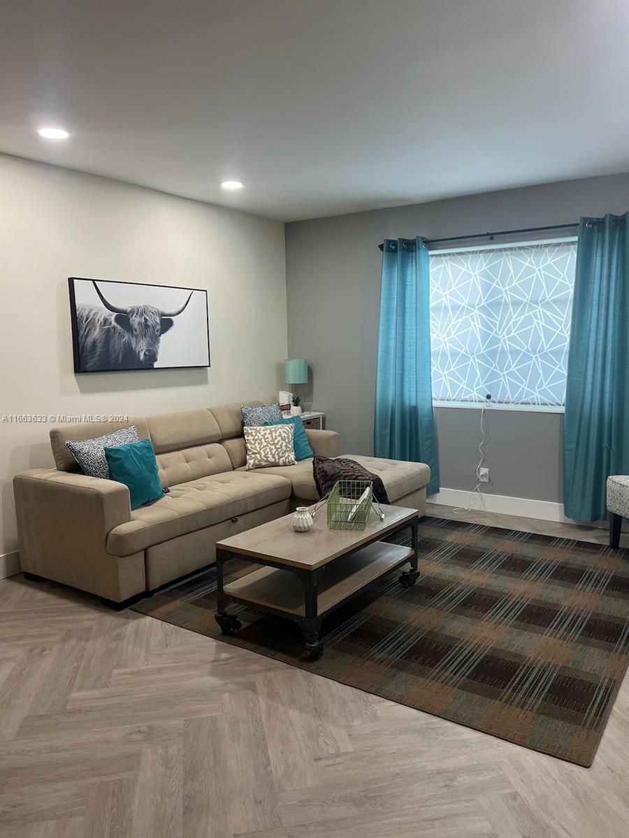 a living room with furniture and a large window