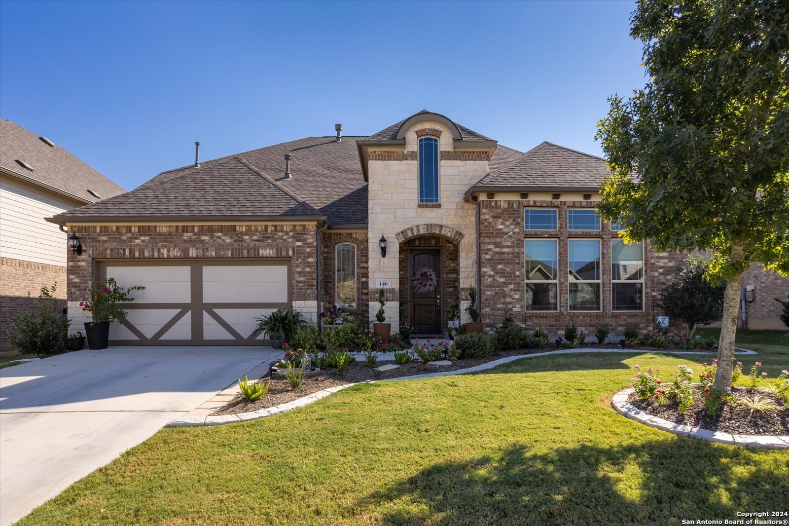 a front view of a house with swimming pool and a yard