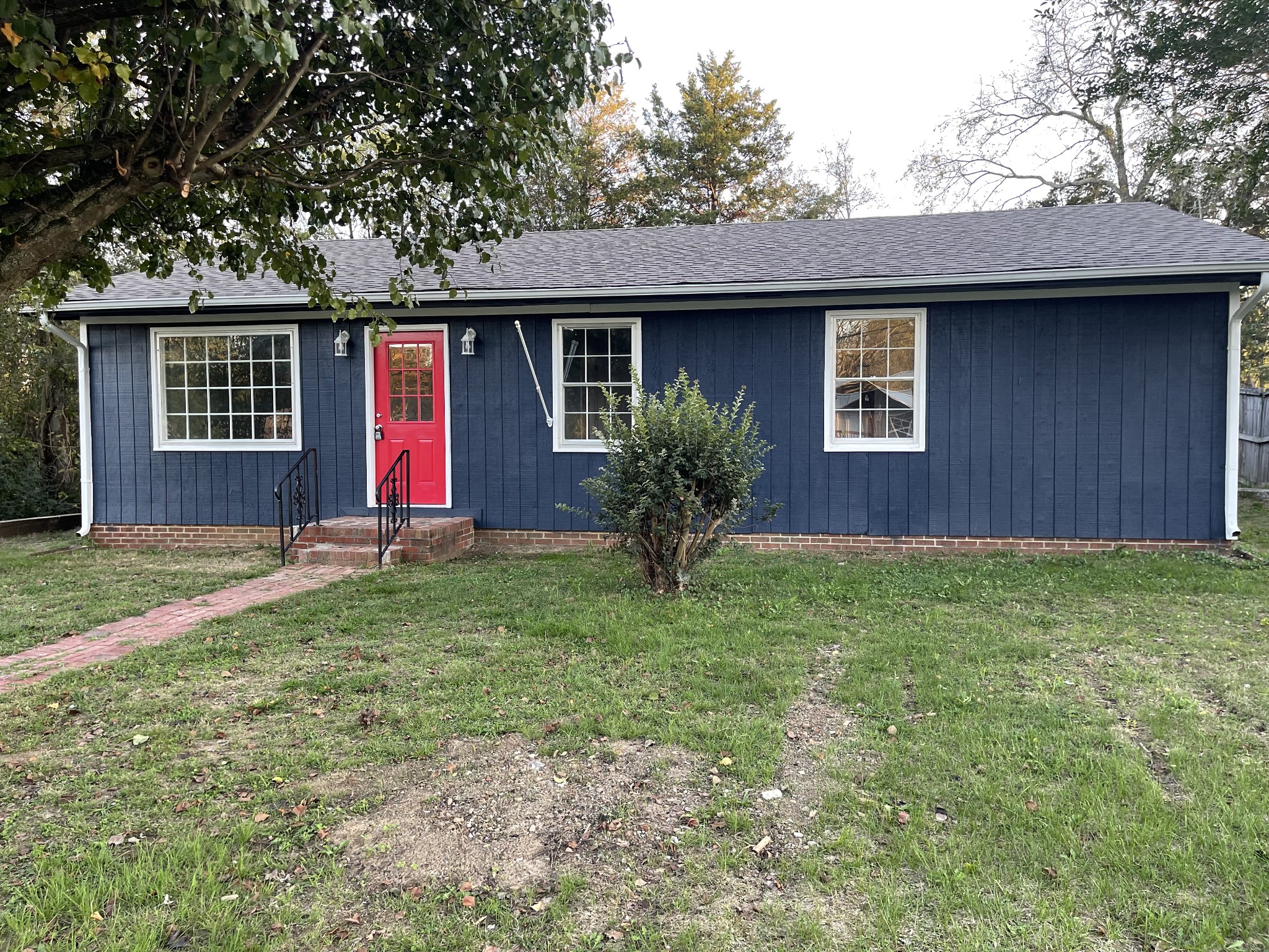 a front view of house with yard and outdoor seating