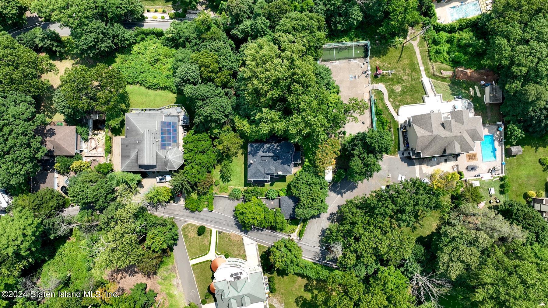 an aerial view of a house with a yard and garden