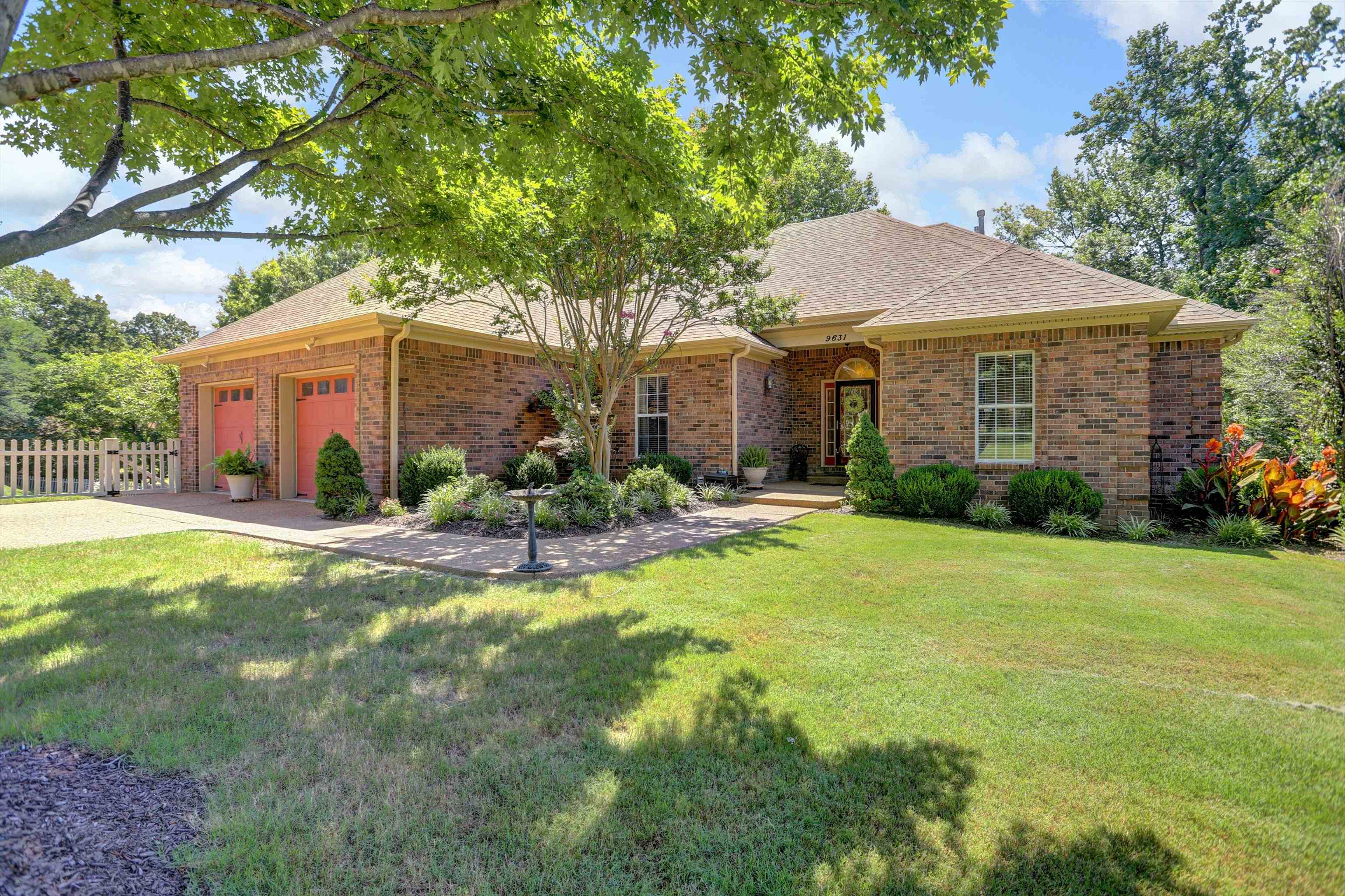 Ranch-style house featuring a front yard and a garage