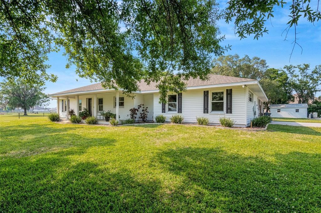 a front view of house with yard and trees