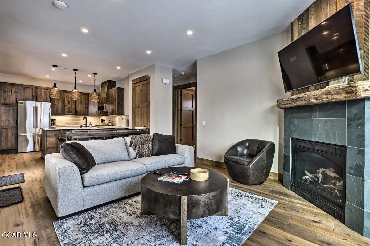 a living room with furniture a flat screen tv and a fireplace