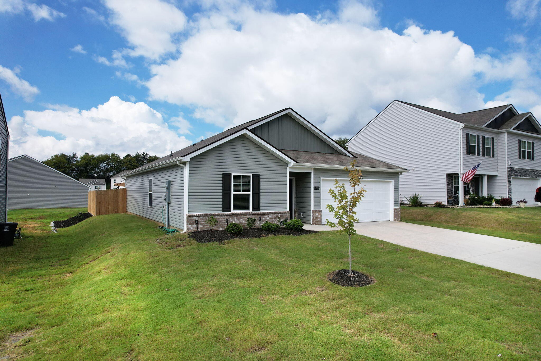 a front view of house with yard and green space