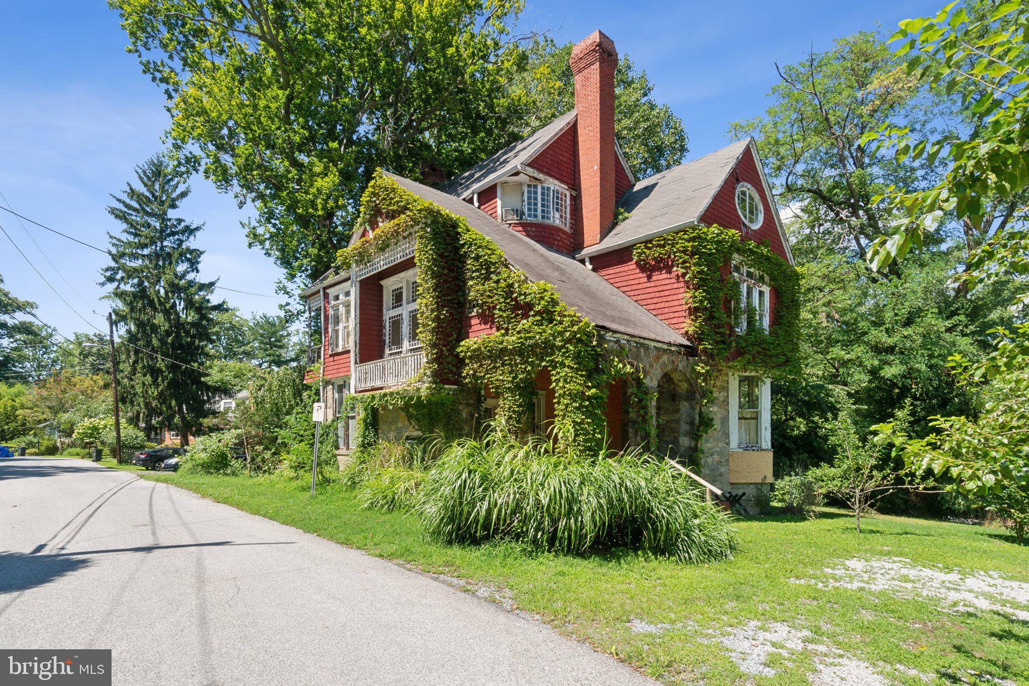 a front view of a house with a yard and green space