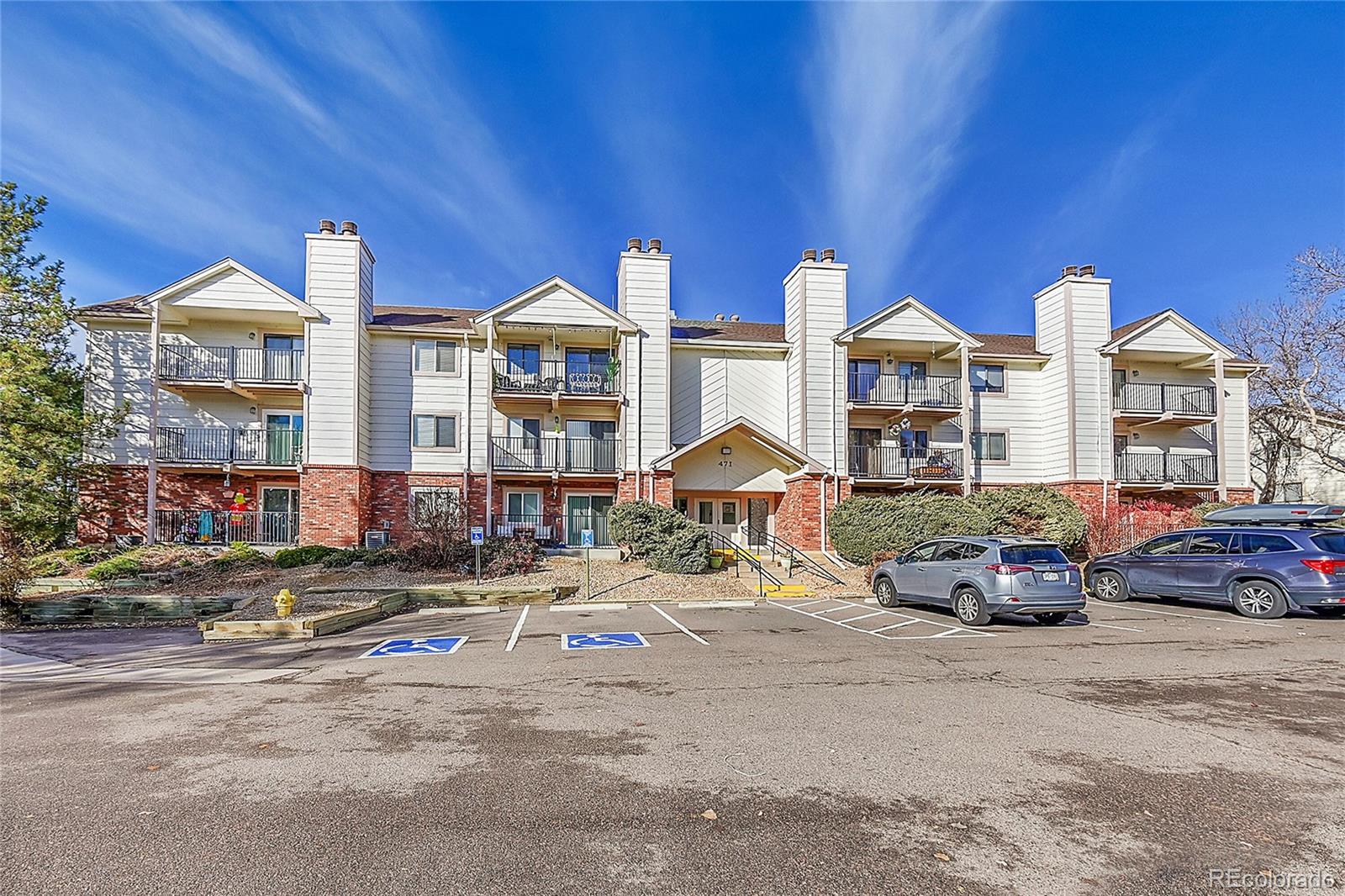 a front view of a residential apartment building with a yard