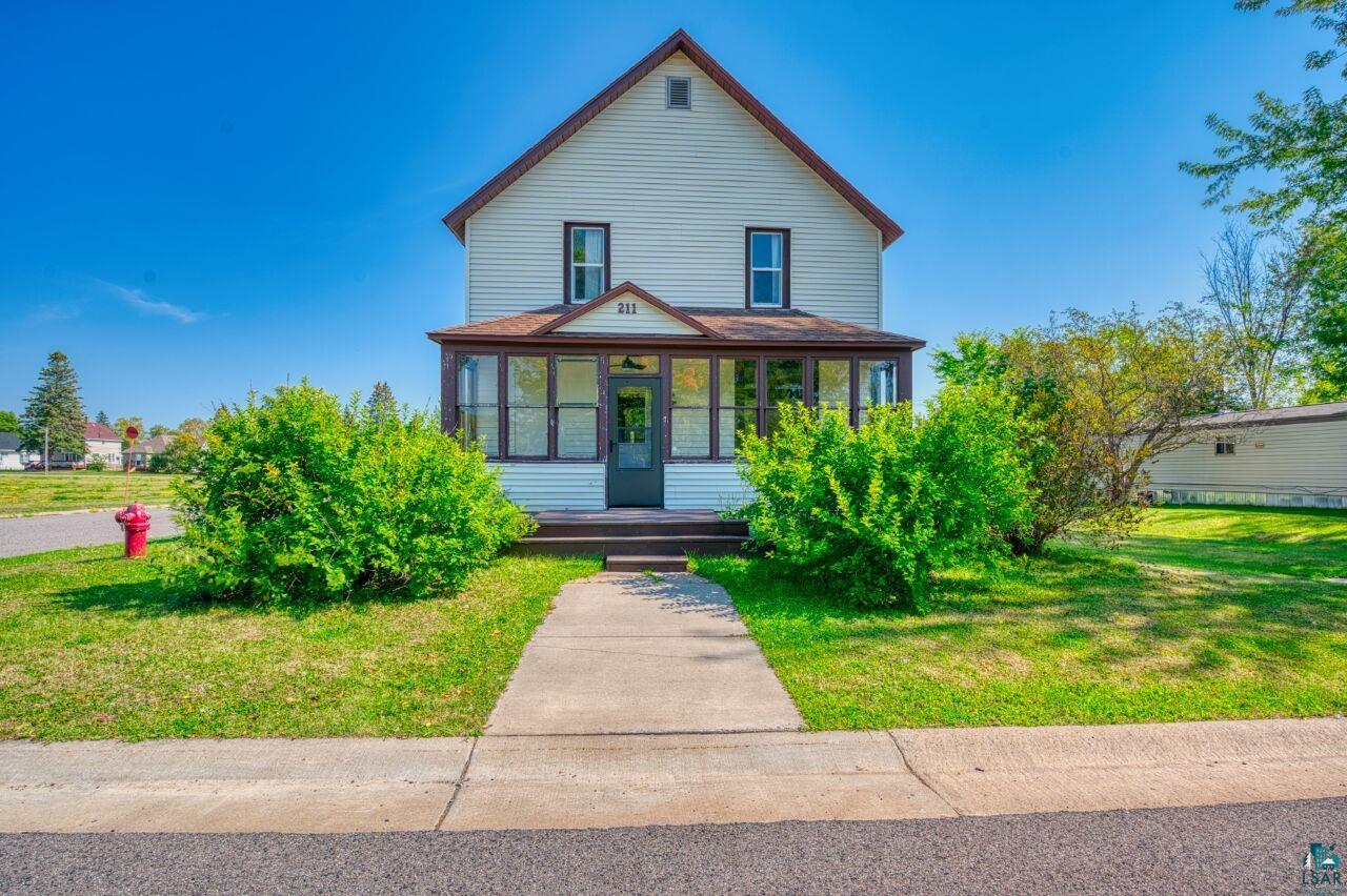 View of front of house featuring a porch and a front lawn