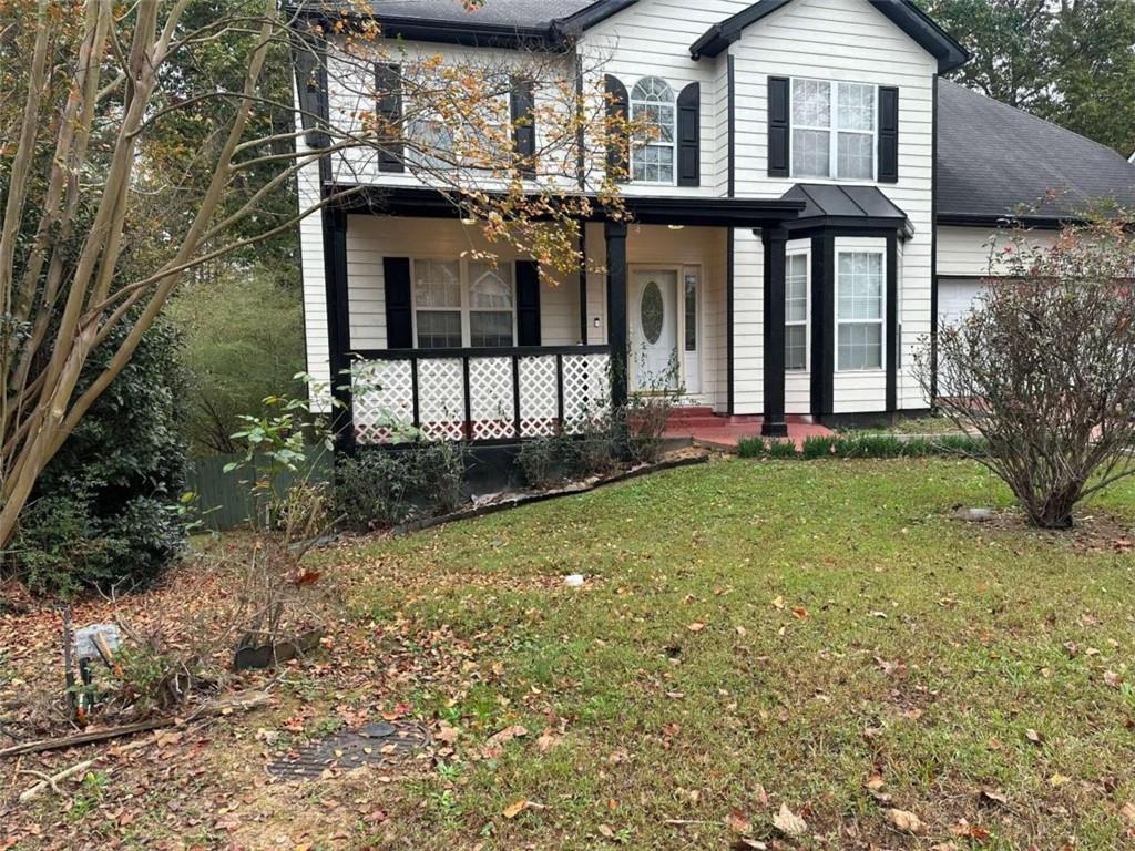 a view of a brick house with a large windows and a yard