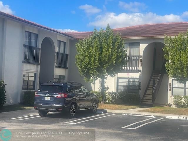 a view of a car in front of a building