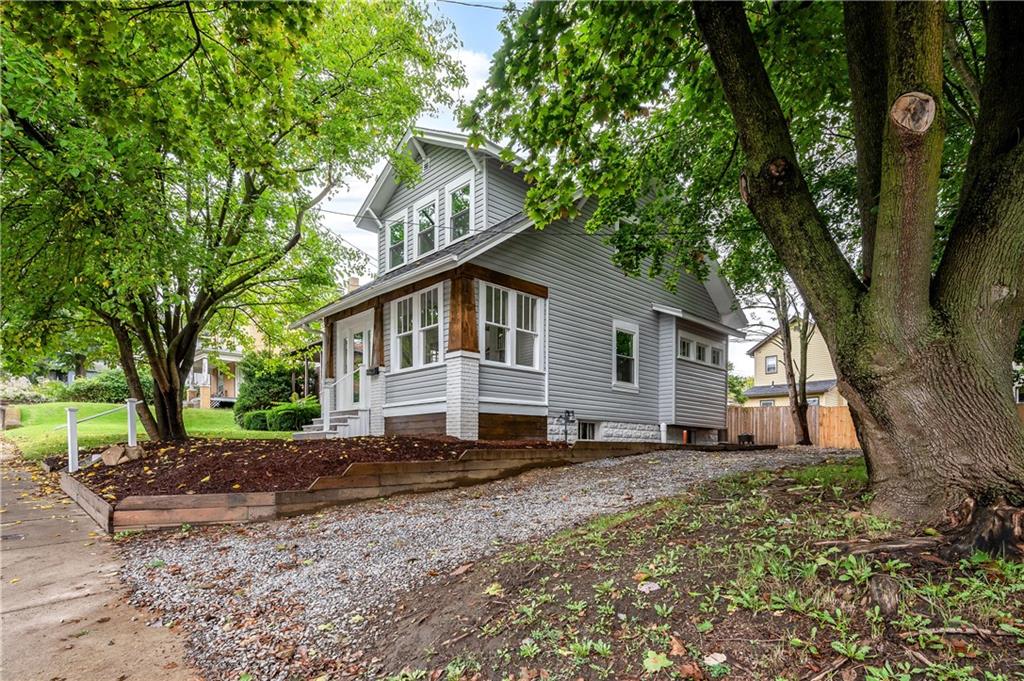 a house that has a tree in front of the house