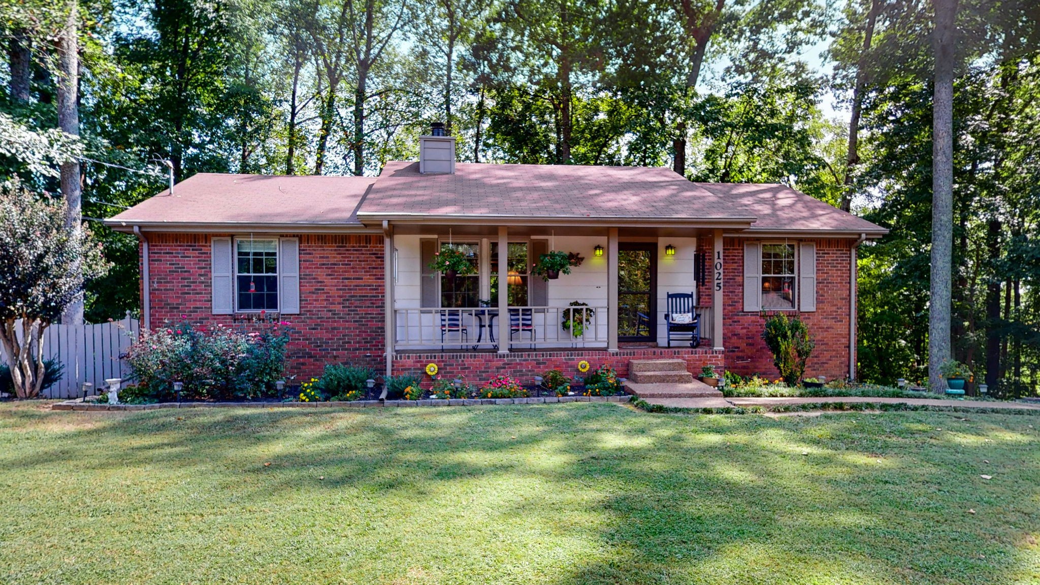 a front view of house with yard and outdoor seating