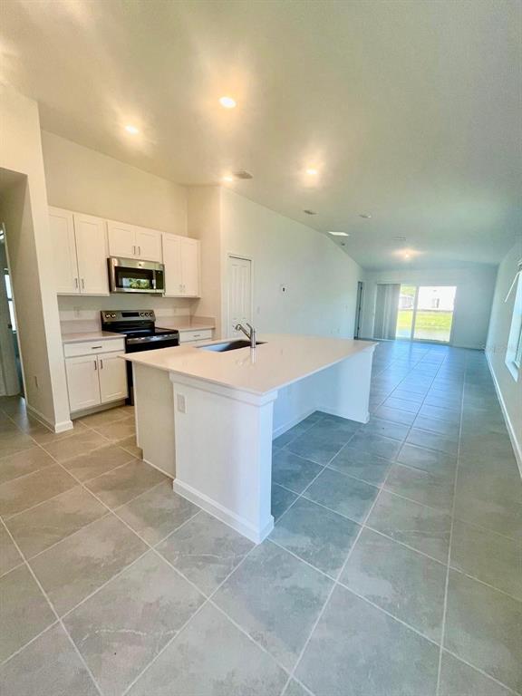 a kitchen with a sink cabinets and stainless steel appliances