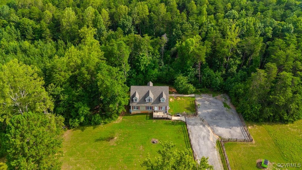 an aerial view of a house with a yard