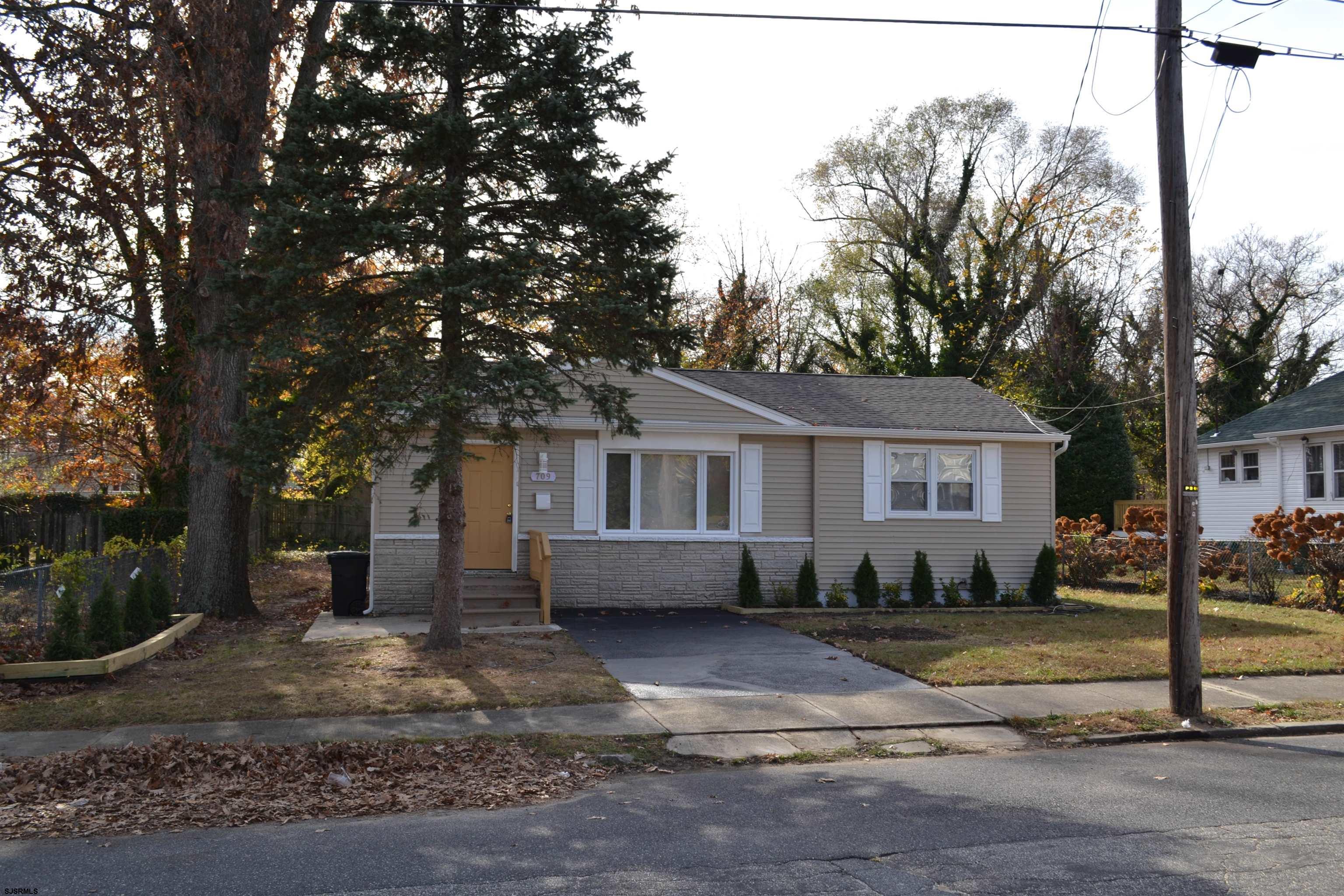 a view of a house with a yard covered with snow in the road