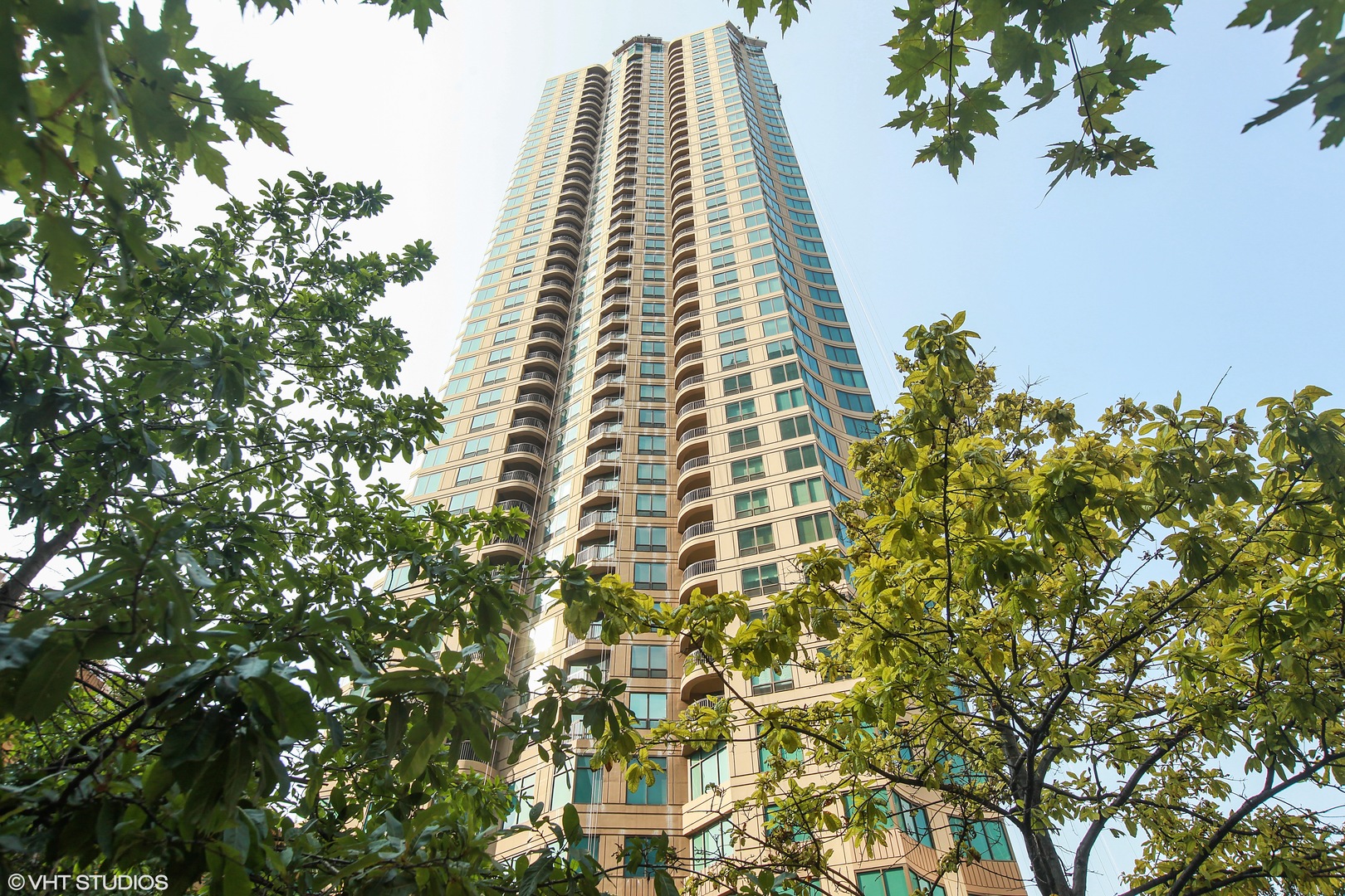 a view of a large building with a tree