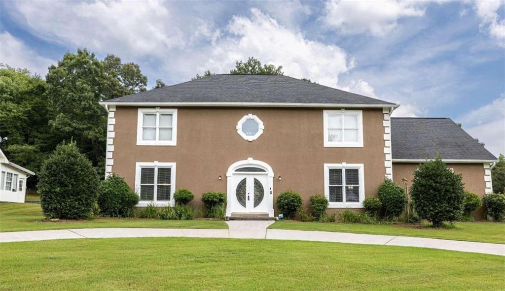 a front view of a house with garden