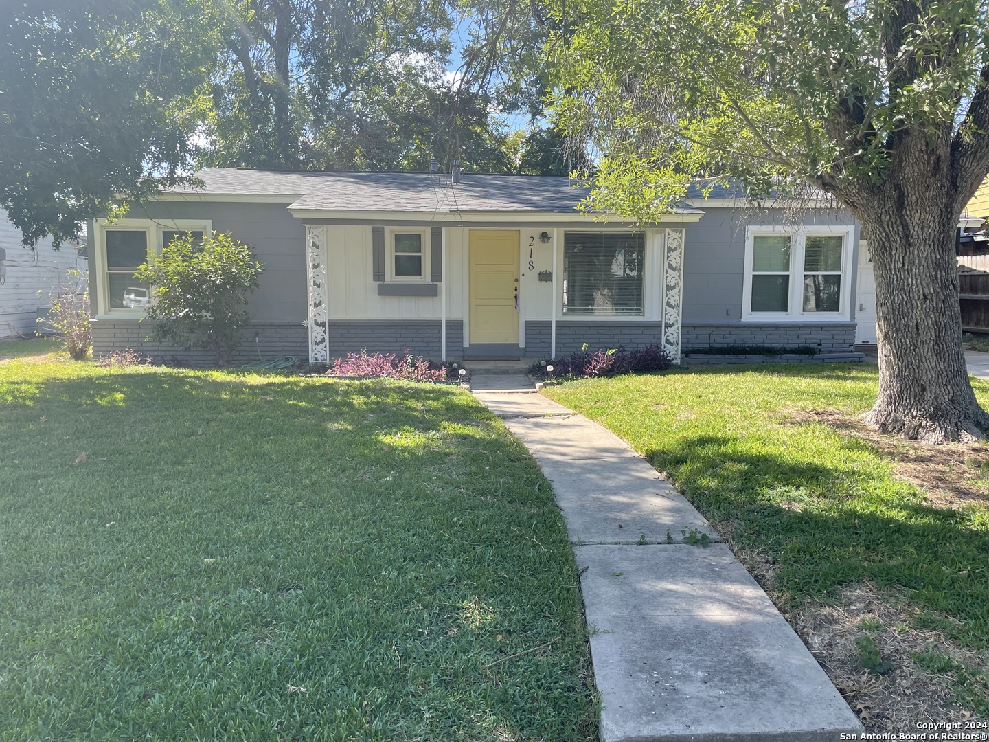 front view of a house with a patio and a yard