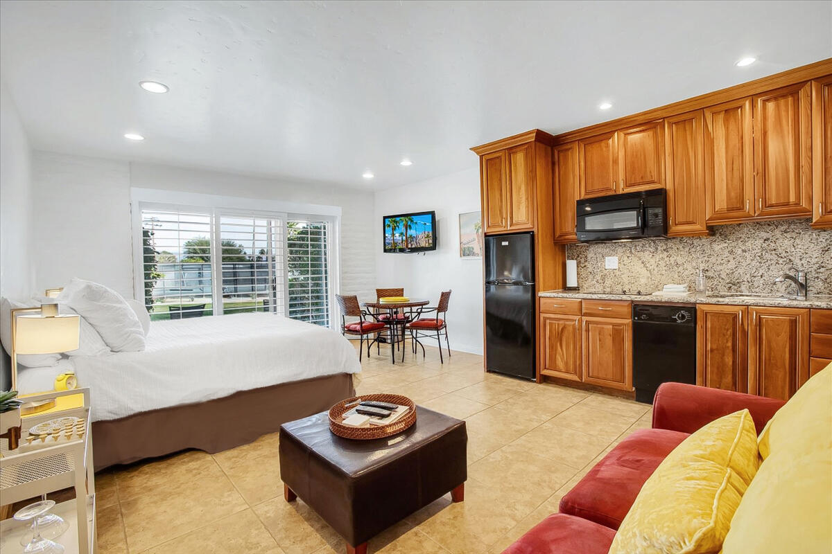 a living room with furniture a window and kitchen view