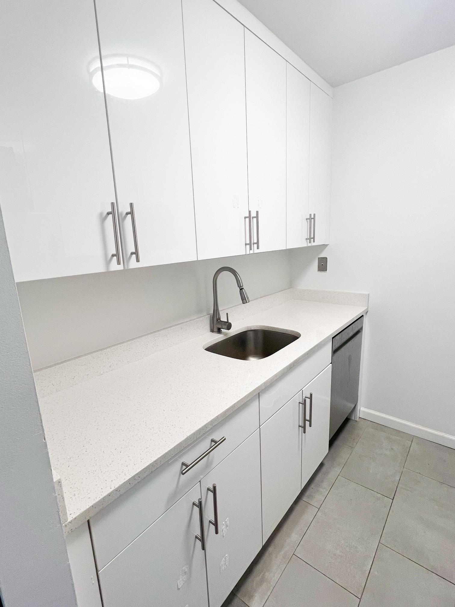 a kitchen with a sink and cabinets