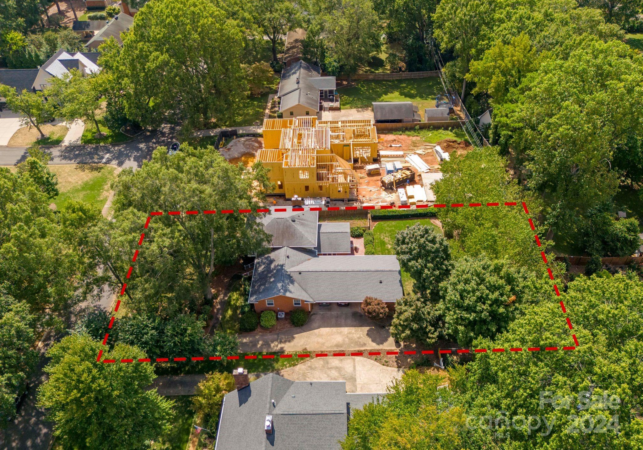 an aerial view of a house with a yard fountain and a large tree