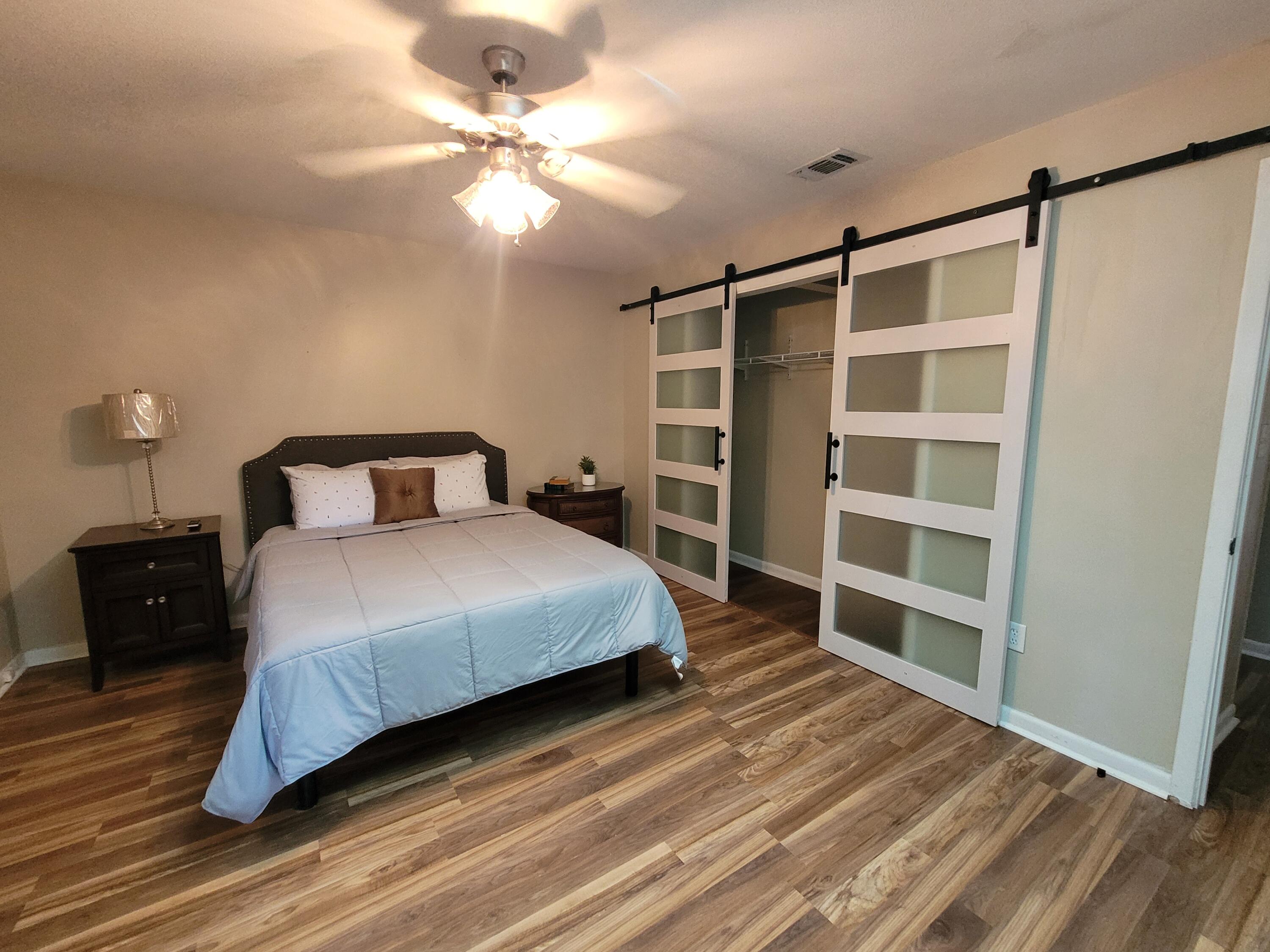 a bedroom with a bed and a chandelier