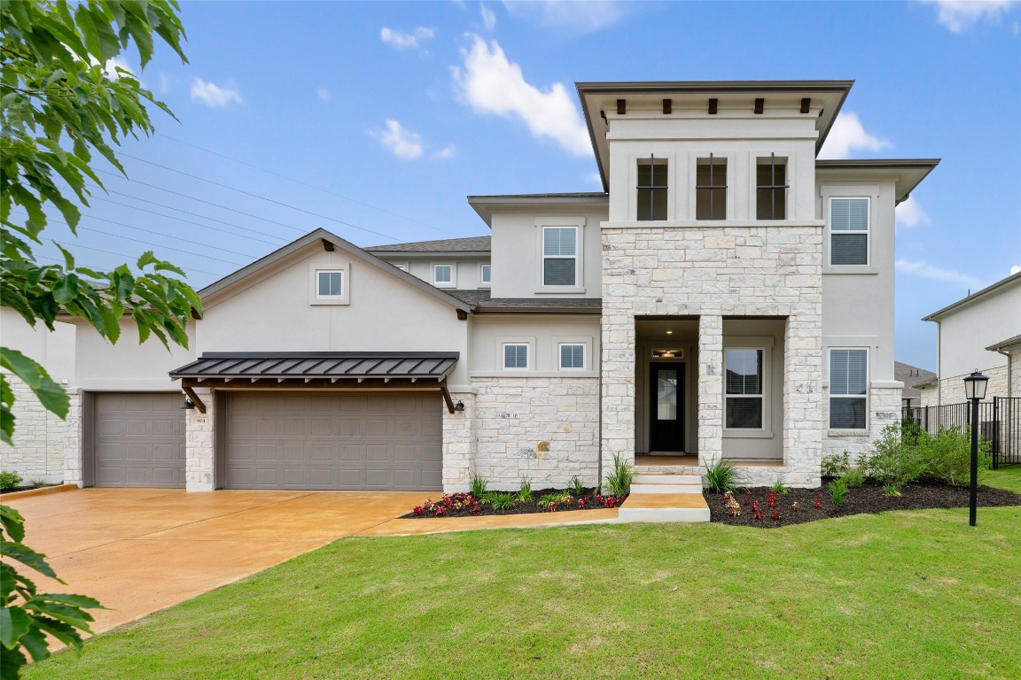 a front view of a house with a yard and garage