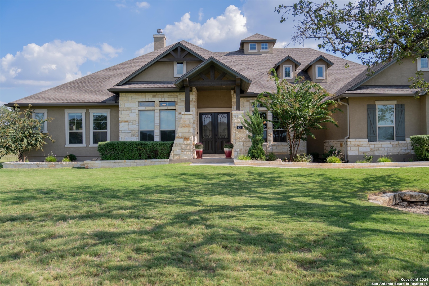 a front view of a house with garden