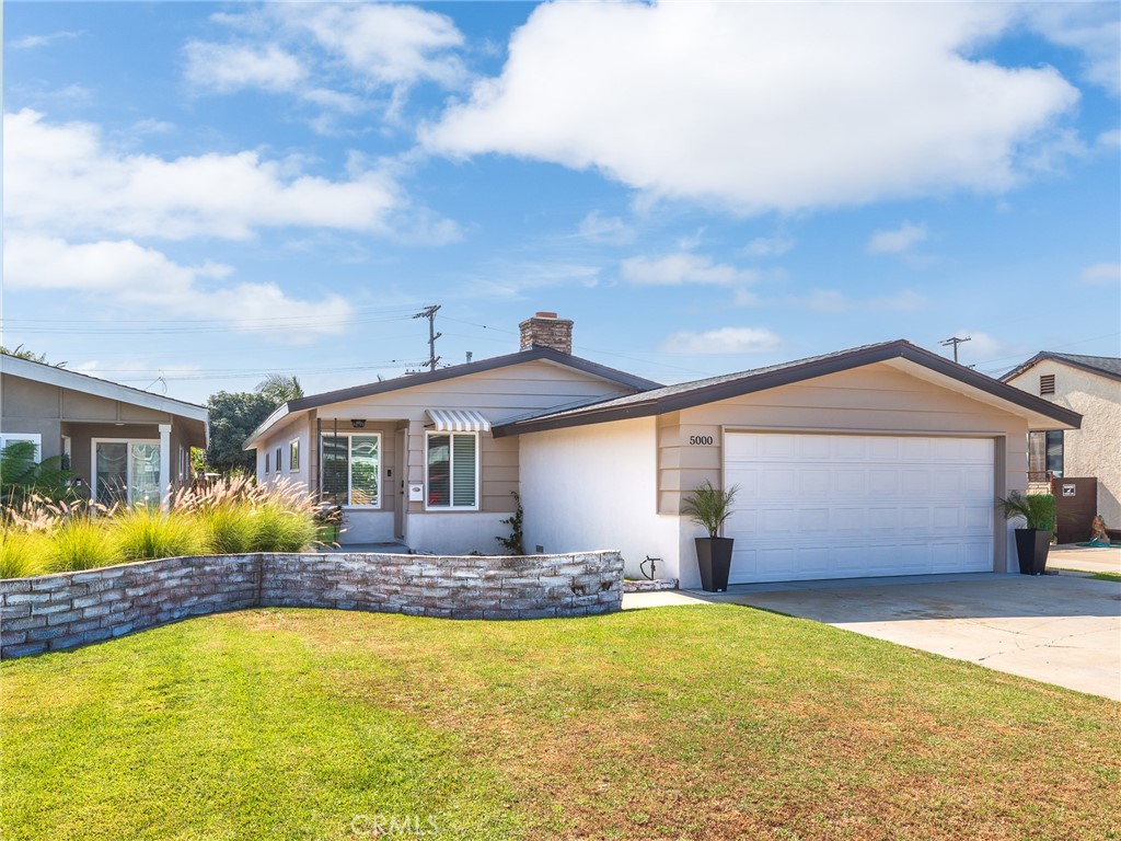 a front view of house with yard and swimming pool