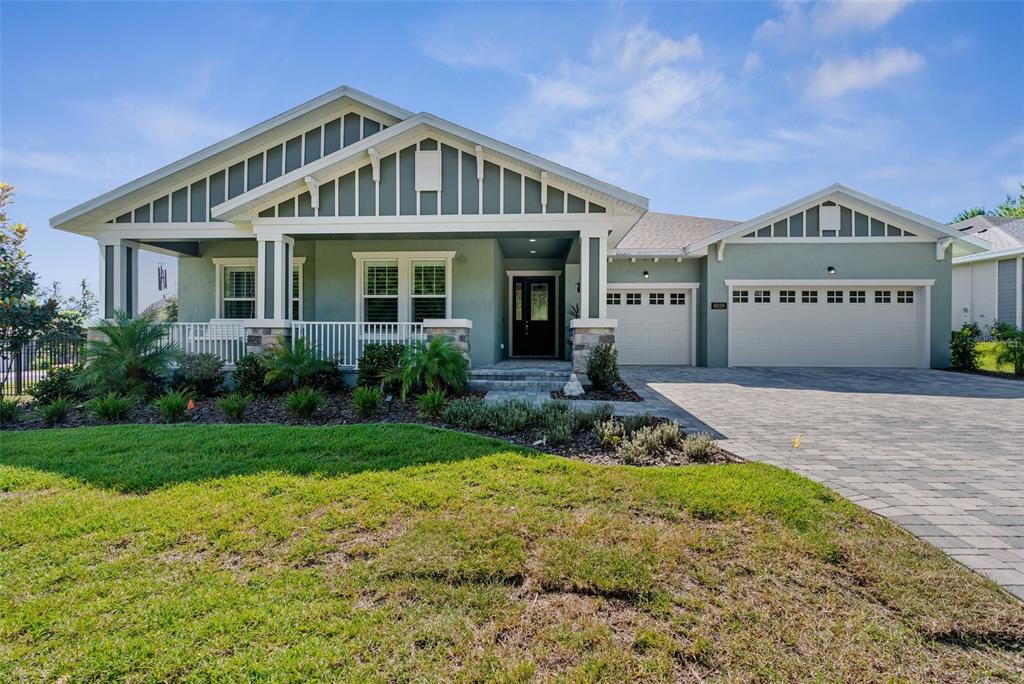 a front view of a house with a yard and porch