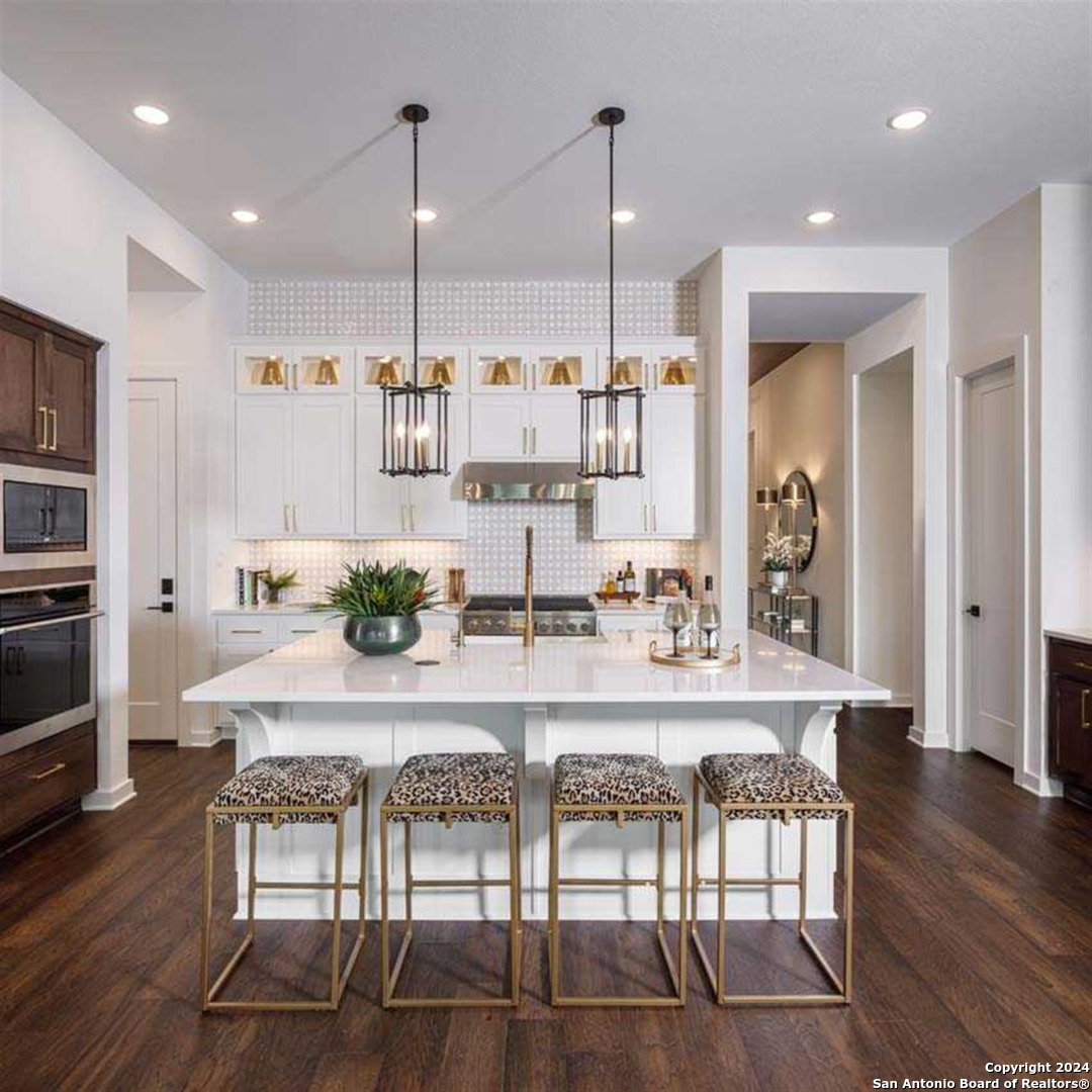 a large kitchen with a table and chairs