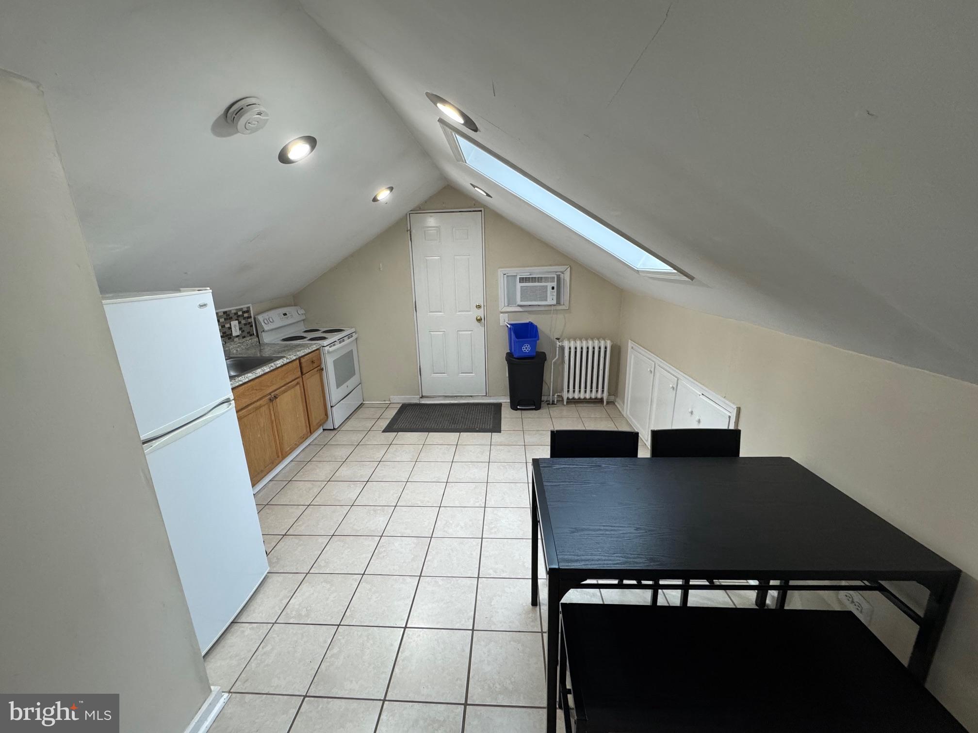 a view of kitchen with sink refrigerator and stove