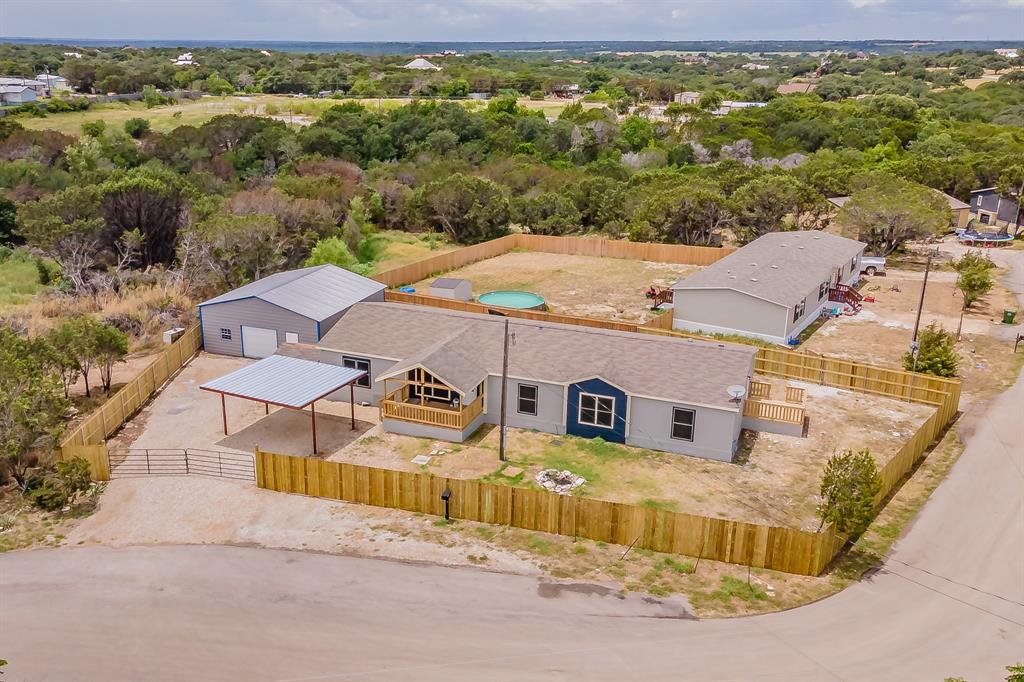 an aerial view of a house with a big yard