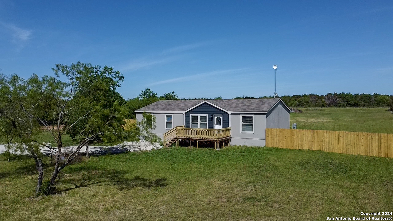 a front view of a house with a garden and yard