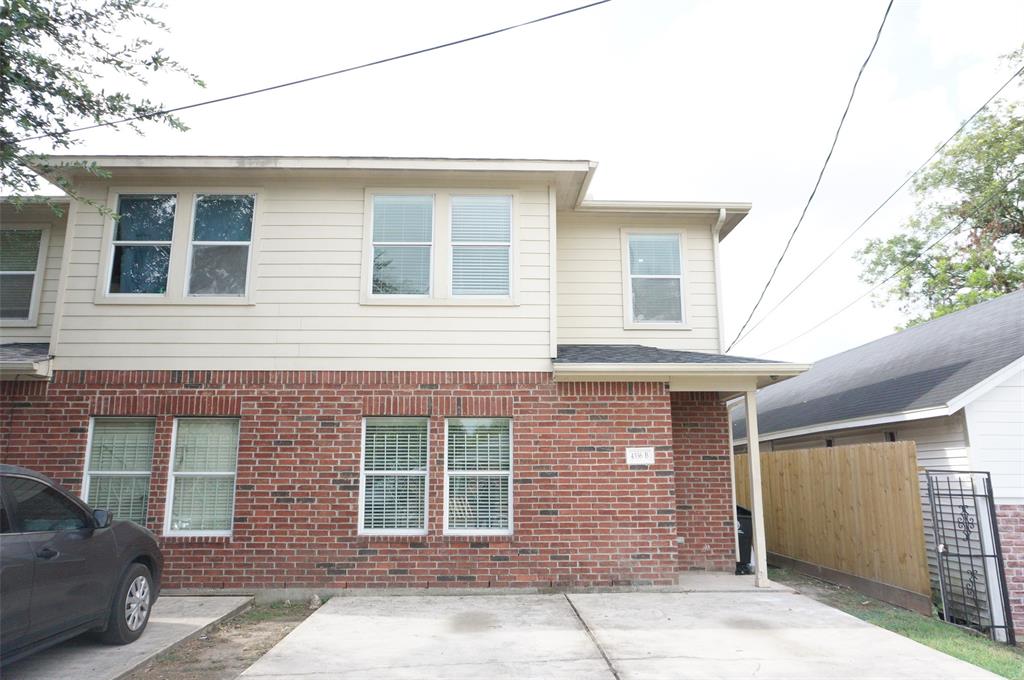 a front view of a house with a parking space