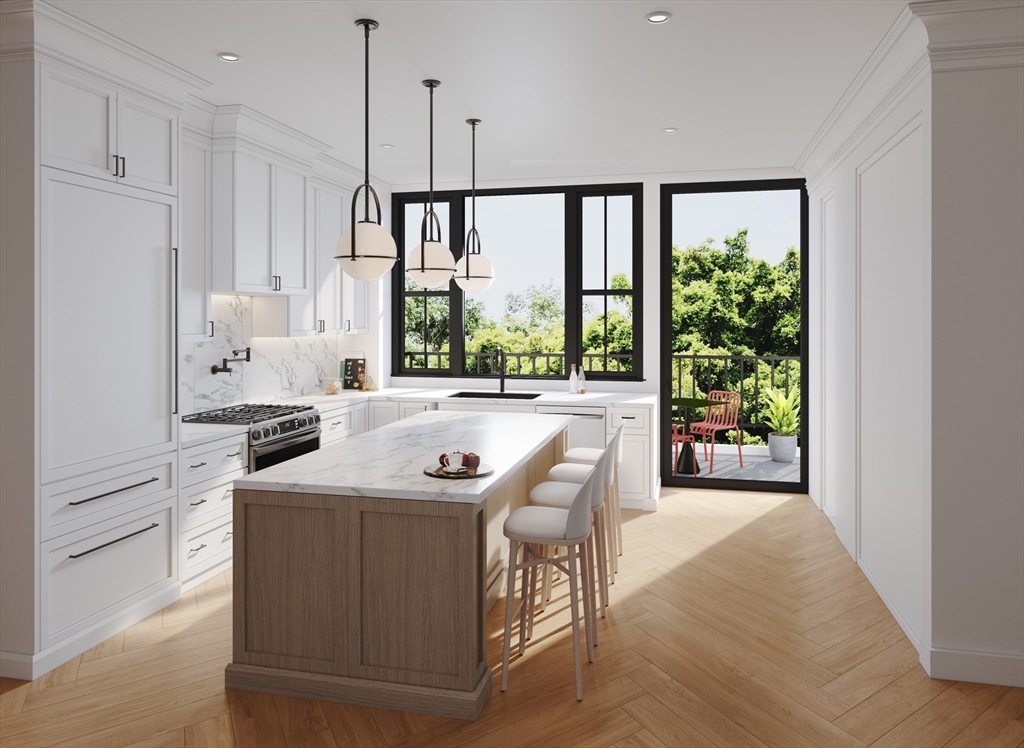 a view of kitchen with stainless steel appliances granite countertop a stove a refrigerator and a view of living room