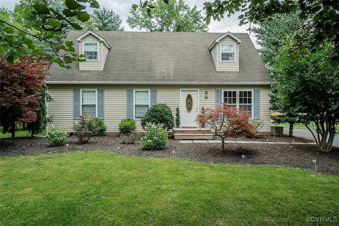 a front view of a house with a garden and plants