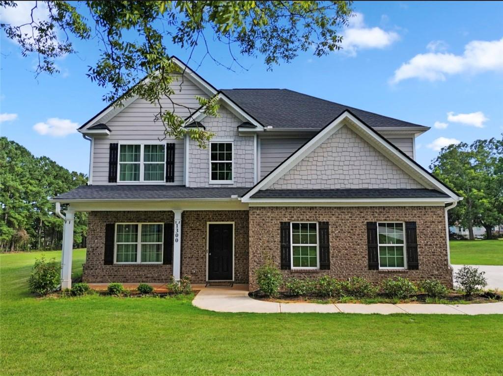 a front view of a house with a yard and porch