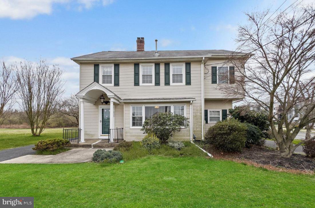 a front view of house with yard and green space