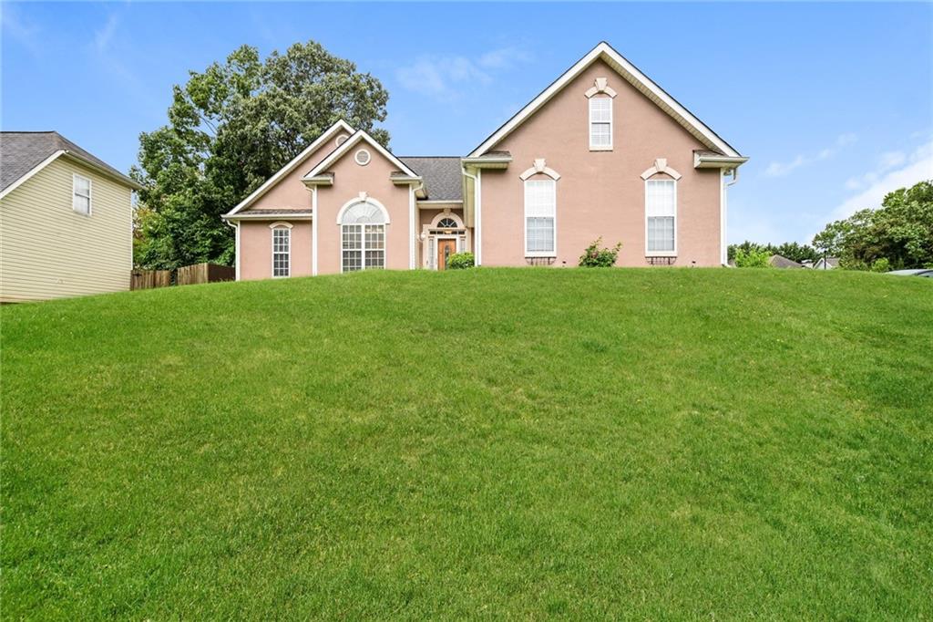 a front view of house with yard and green space