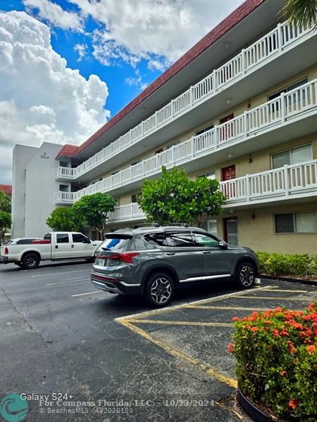 a view of a cars park in front of a building