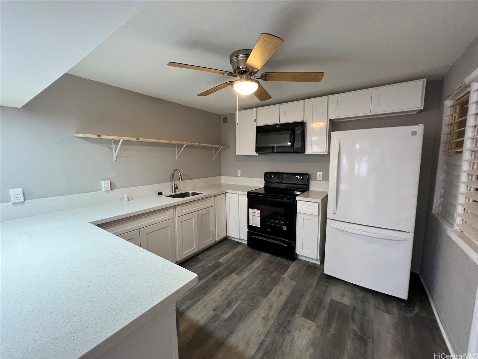 a kitchen with a refrigerator a sink and a stove