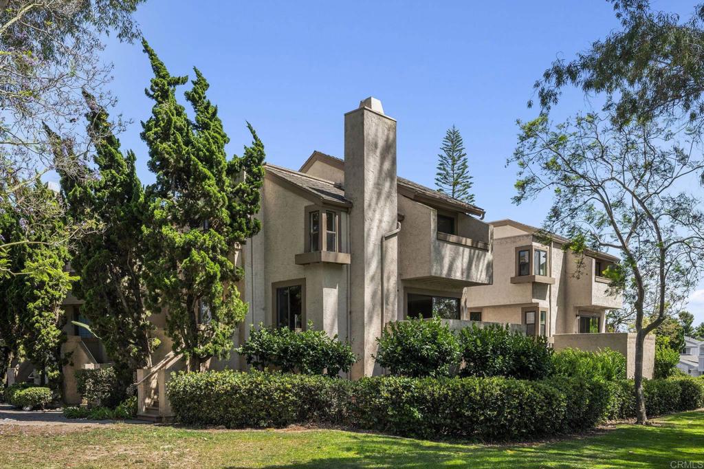 a front view of a residential houses with yard and green space