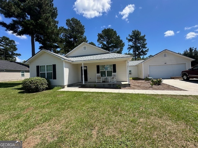 a view of a house with backyard and sitting area