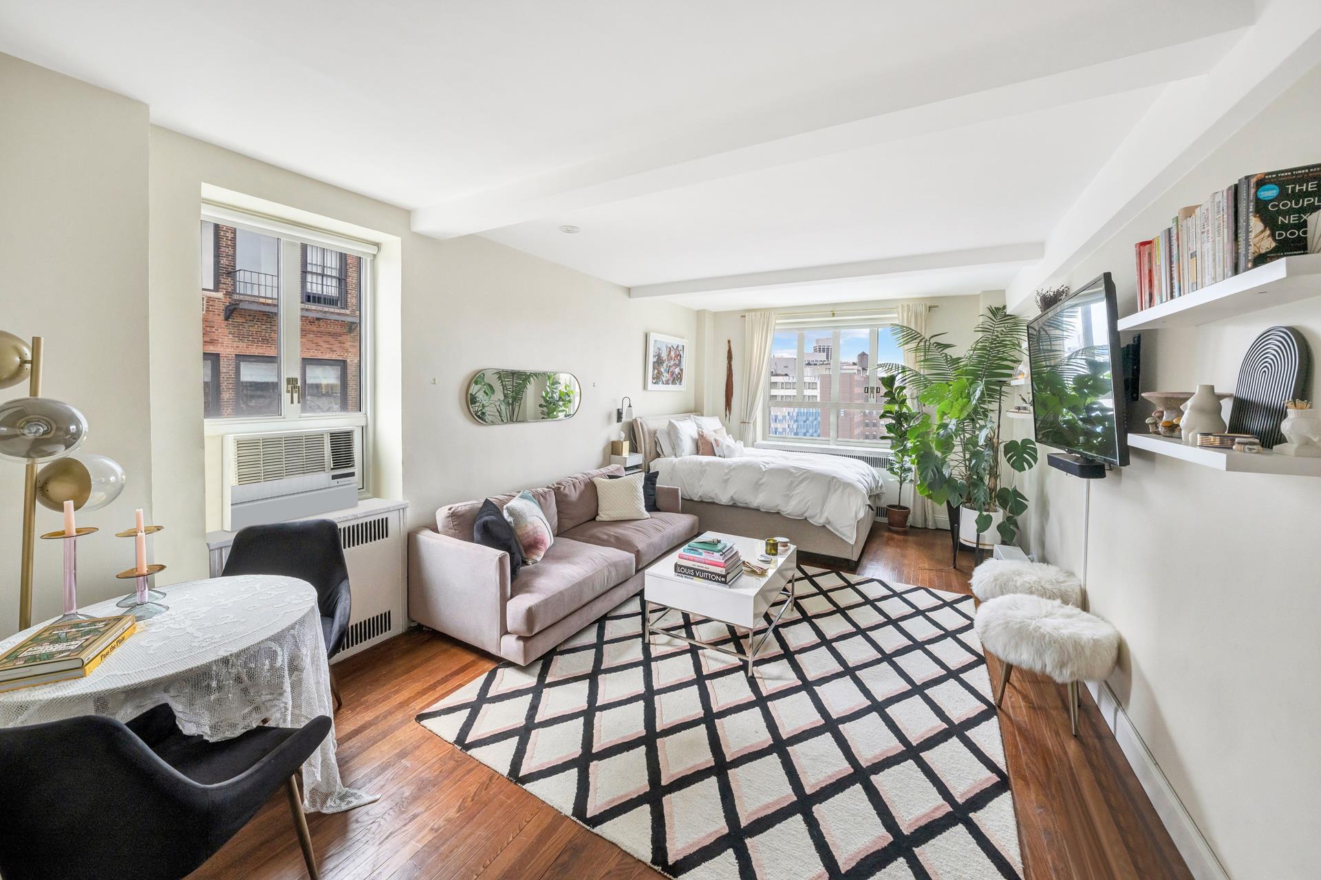 a living room with furniture fireplace and a large window