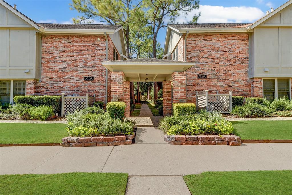 a front view of a house with plants