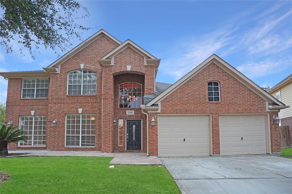 a front view of a house with a yard and garage