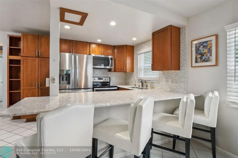 a kitchen with a table chairs refrigerator and cabinets