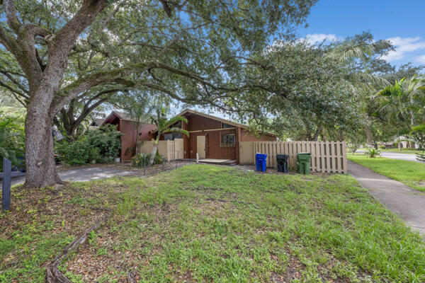 a house is sitting in middle od the grass