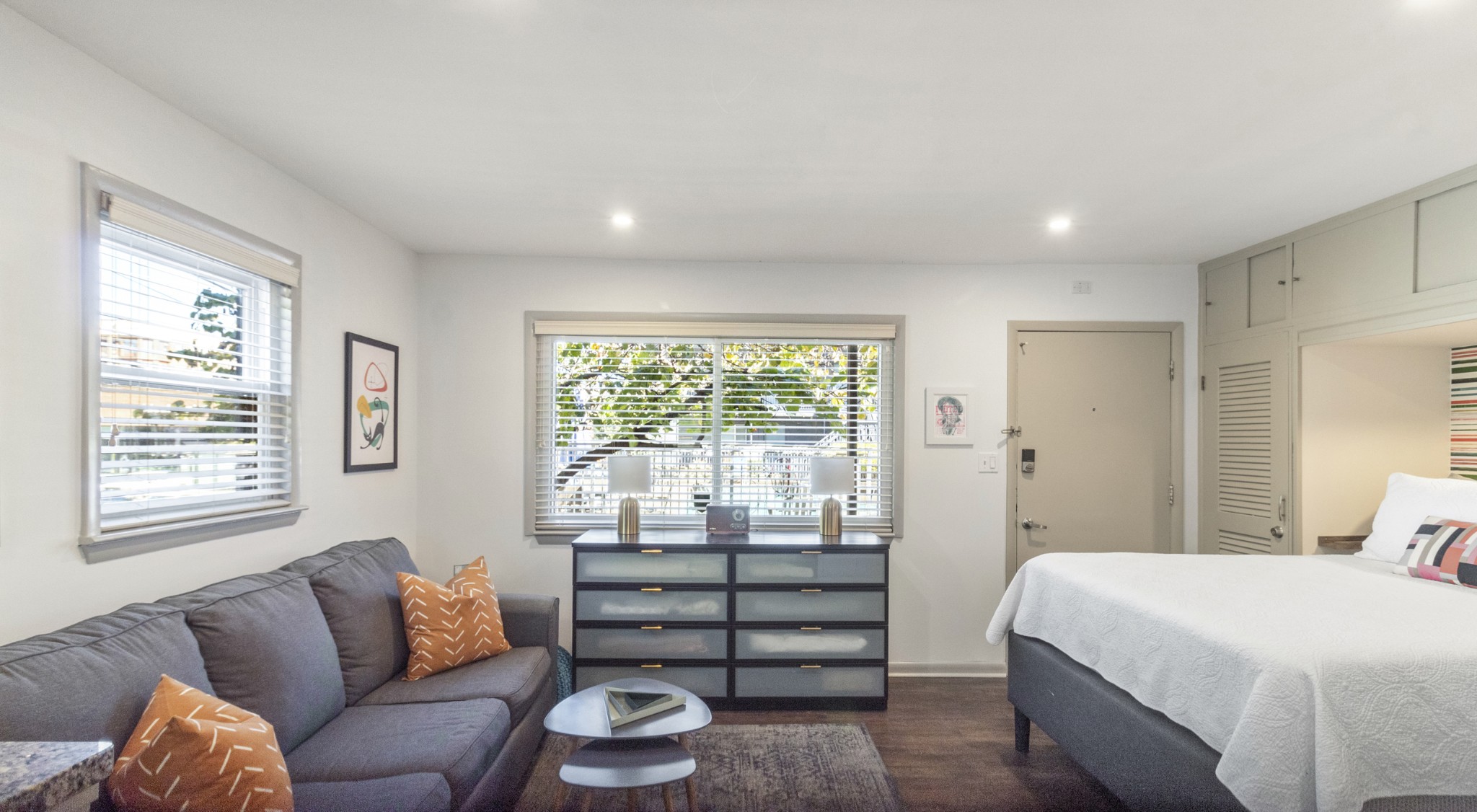 a bedroom with furniture and a large window